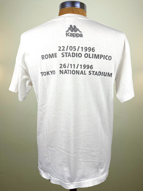 A white Kappa short-sleeve T-shirt displayed on a mannequin torso, showing the back with black printed text and logos for Rome and Tokyo stadium matches on 22/05/1996 and 26/11/1996.
