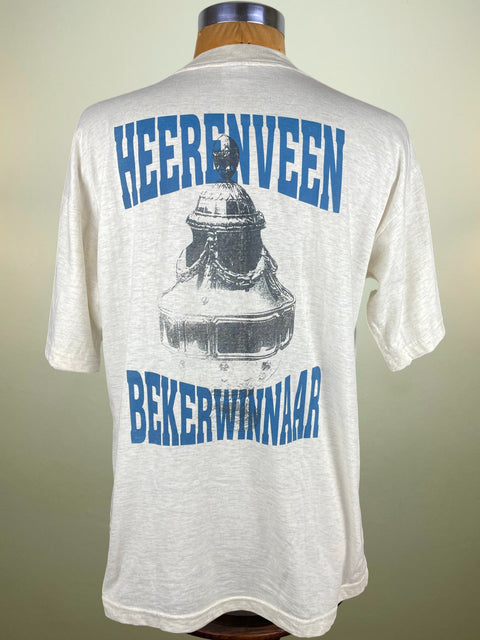 White t-shirt with blue text and graphic on a mannequin against a neutral background
