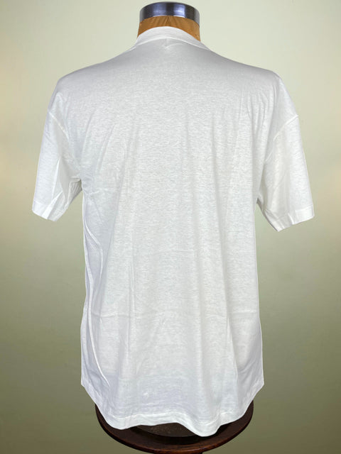 White short-sleeve shirt on a mannequin against a beige background