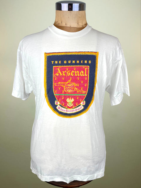 White t-shirt with Arsenal logo on a mannequin against a beige background