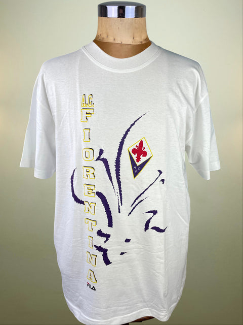 White t-shirt with Fiorentina logo and text on a mannequin against a beige background