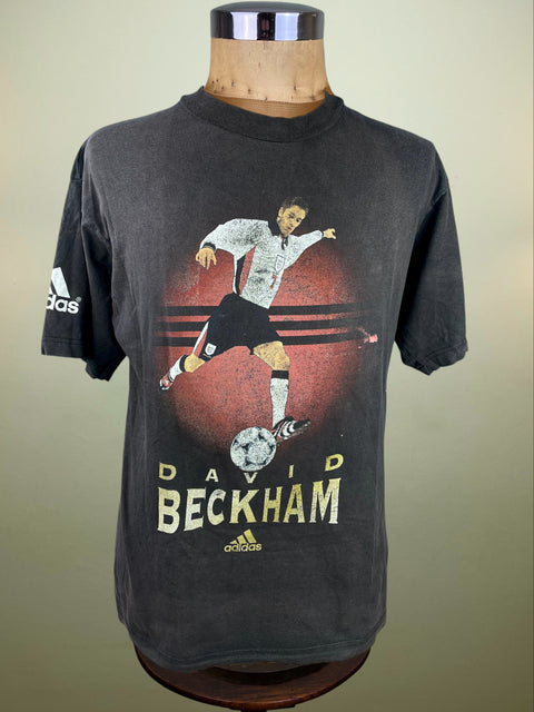 Black t-shirt with David Beckham graphic on a mannequin against a beige background