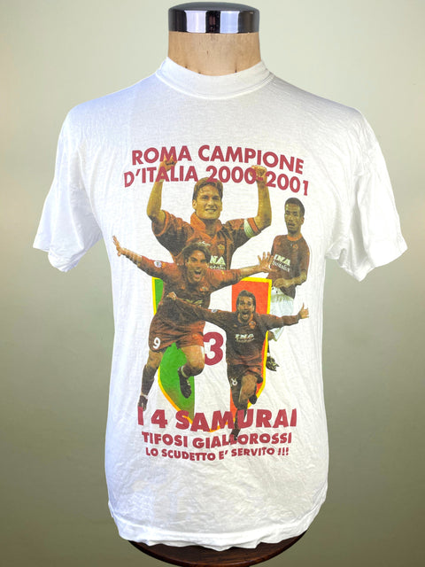 White t-shirt with soccer player graphics and text on a mannequin against a plain background