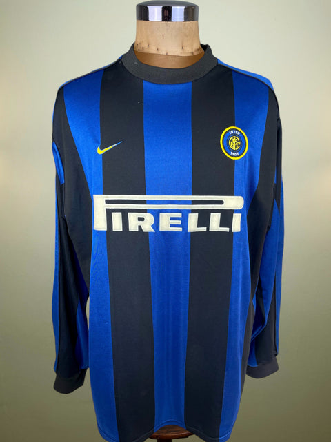 Blue and black Inter Milan 1999-00 home jersey with Pirelli logo on a mannequin against a beige background