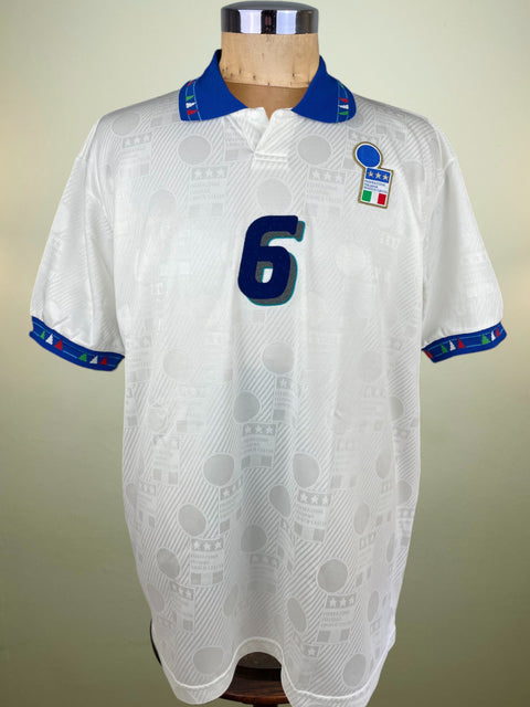 White Italy World Cup 1994 jersey with number 6 on a mannequin against a beige background