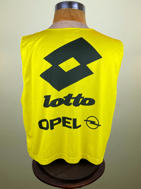 Yellow sleeveless AC Milan Training Bib with Lotto and Opel logos on a mannequin against a plain background