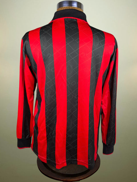Red and black striped AC Milan Intercontinental Cup Final shirt with a Lotto logo on a mannequin against a beige background