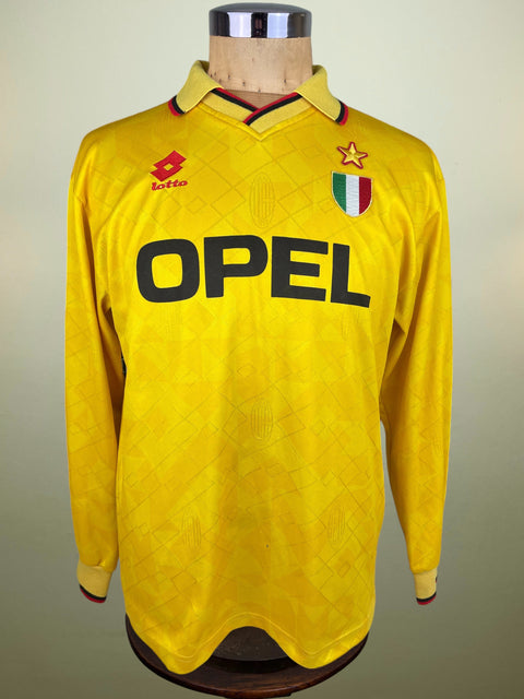 Yellow AC Milan Super Cup Final jersey with Opel logo on a mannequin against a plain background