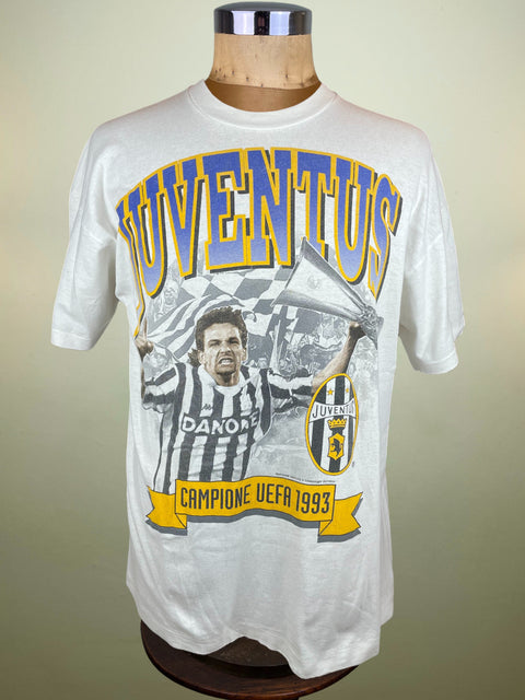 White t-shirt with Juventus logo and text on a mannequin against a beige background