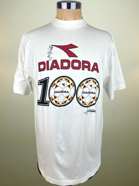 White t-shirt with Diadora branding on a mannequin against a beige background