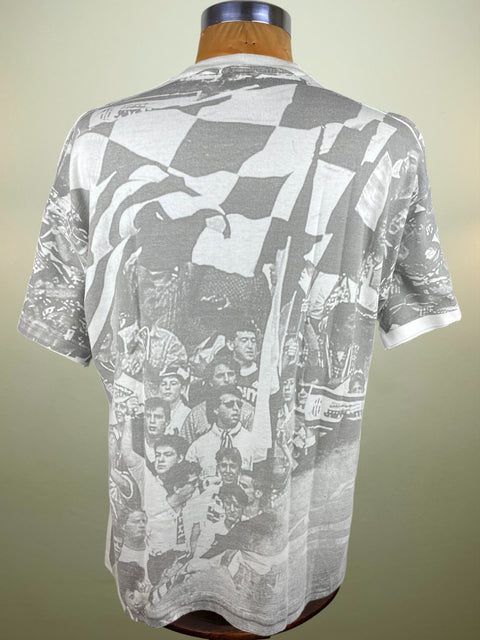 Gray t-shirt with black and white graphic design on a mannequin against a beige background
