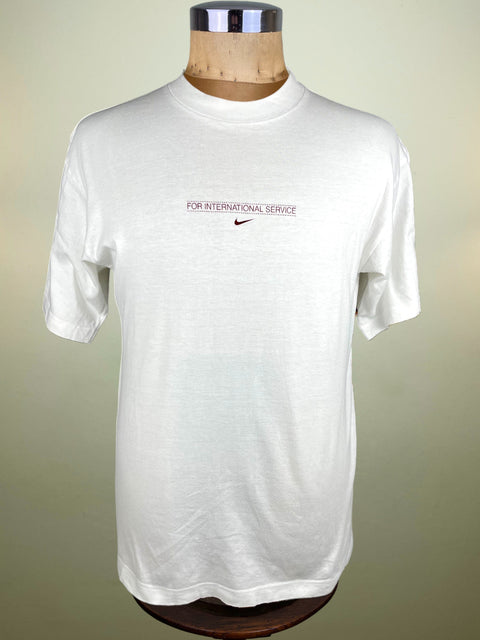 White t-shirt with Nike logo on a mannequin against a beige background