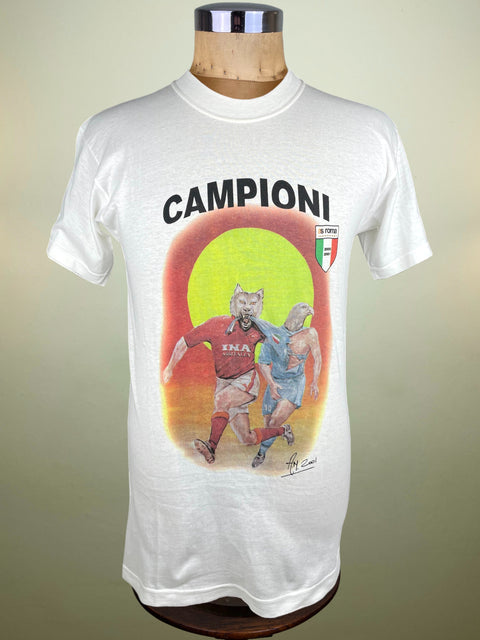 White AS Roma t-shirt with 'Campioni' graphic on a mannequin against a beige background