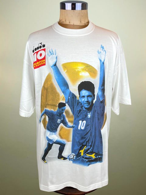 White Diadora t-shirt with Roberto Baggio graphic and Diadora logo on a mannequin against a beige background