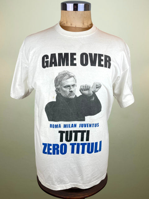 White t-shirt with Jose Mourinho and text saying Zero Titles for Roma Milan and Juve on a mannequin against a plain background