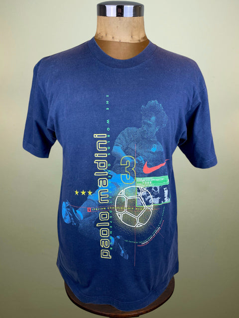 Blue Nike t-shirt with soccer design and 'Paolo Maldini' text on a mannequin against a beige background