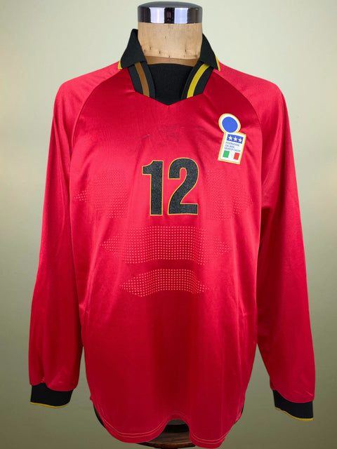 Red Nike Italy Goalkeeper jersey with number 12 on a mannequin against a beige background