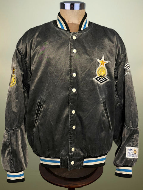 Black Inter Milan Umbro varsity jacket with logos on a mannequin against a gray background