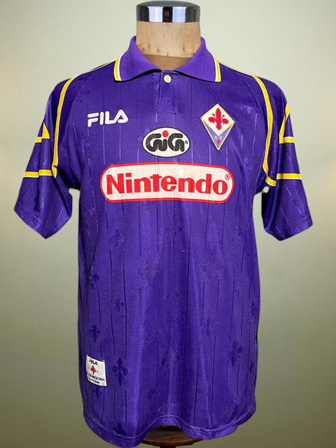 Purple Fiorentina 1997-98 jersey with logos on a mannequin against a neutral background