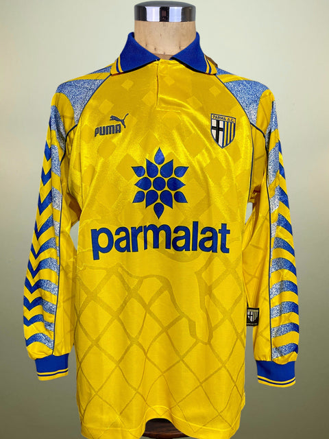 Yellow Parma 1995-97 jersey with blue accents on a mannequin against a neutral background