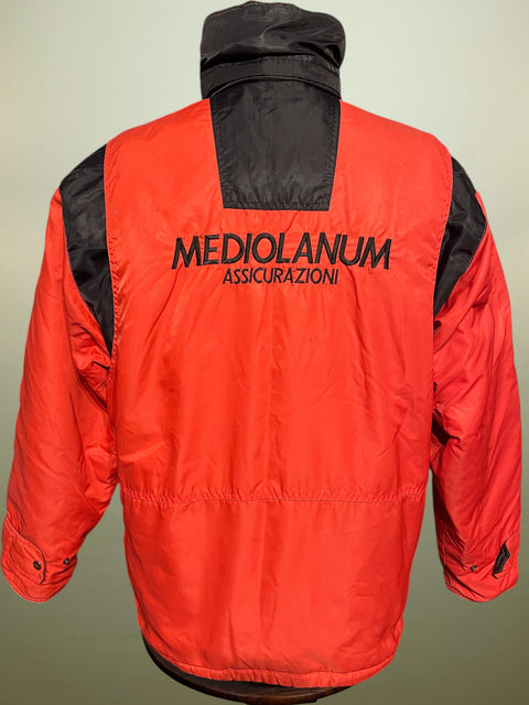 Red AC Milan 1988 Bench Coat with black accents and 'Mediolanum Assicurazioni' text on a neutral background