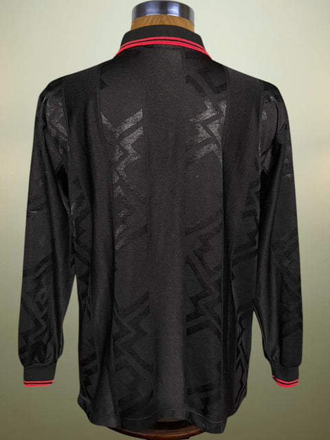 Black AC Milan 1996-97 Shirt with red accents on a mannequin against a beige background