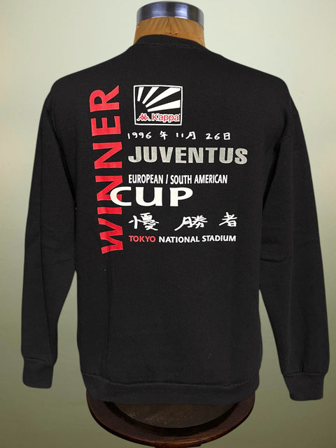 Black sweatshirt with text and logo on a mannequin against a beige background