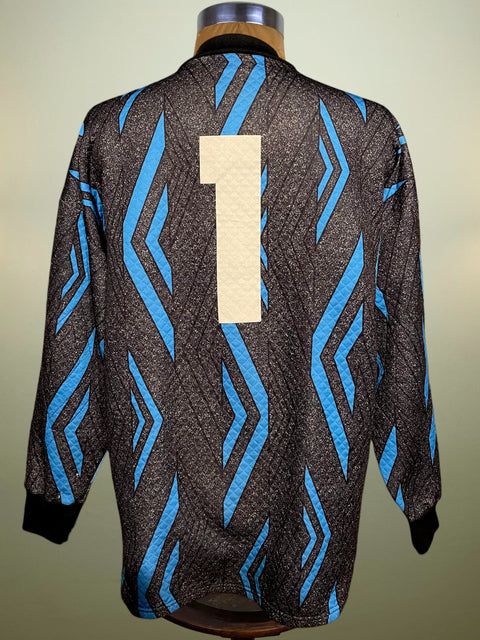 Black and blue patterned jacket with a beige number '1' on a mannequin against a neutral background