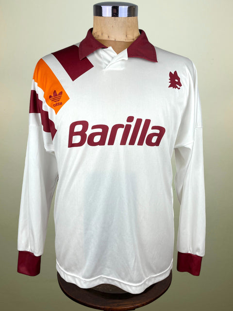 White AS Roma 1993 jersey with red and orange accents on a mannequin against a beige background