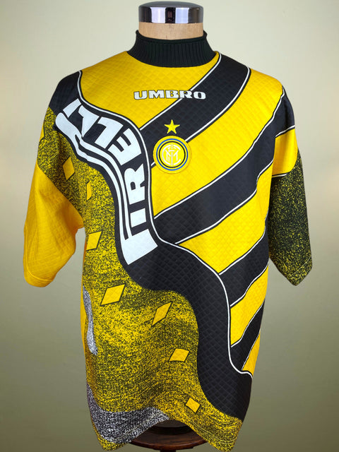 Yellow and black Inter Milan  1995-96 Goalkeeper jersey with Umbro branding on a mannequin against a beige background