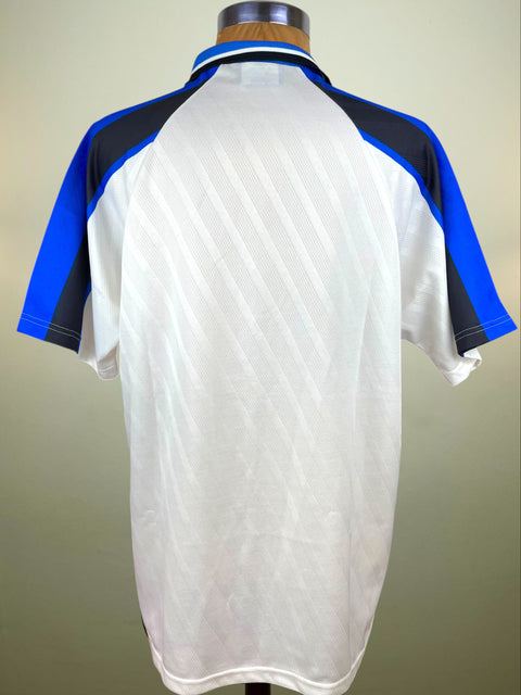 White Inter Milan UEFA Cup Final jersey with blue and black accents on a 
mannequin against a beige background