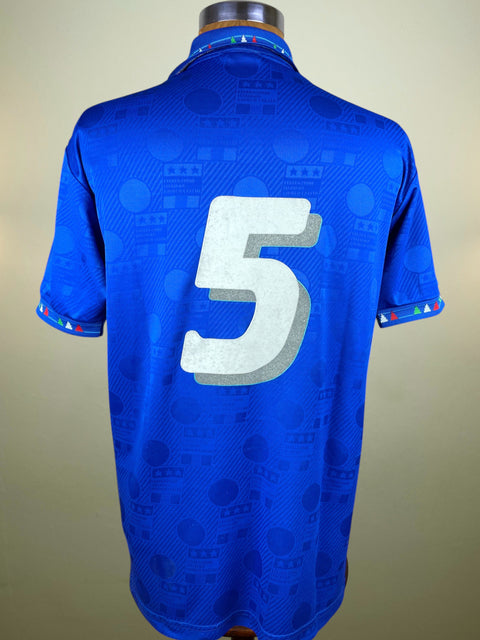 Blue Italy Diadora World Cup 94 jersey with number 5 on a mannequin against a beige background