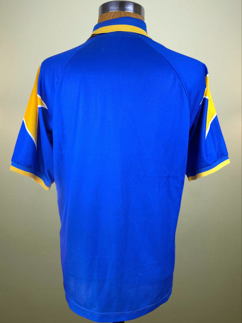 Blue Juve 1994-95 away shirt made by Kappa with yellow accents on a mannequin against a beige background