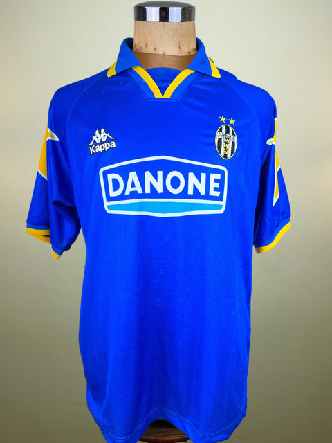 Blue Juve 1994-95 away shirt made by Kappa with Danone sponsor on a mannequin against a beige background