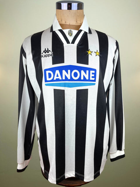 Black and white striped shirt Juventus Kappa Shirt from the 1994-95 Season with Danone logo on a mannequin against a neutral background