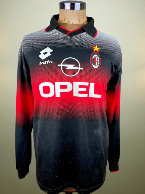 Black and red AC Milan 1996-97 Training jersey with brand logos on a mannequin against a neutral background