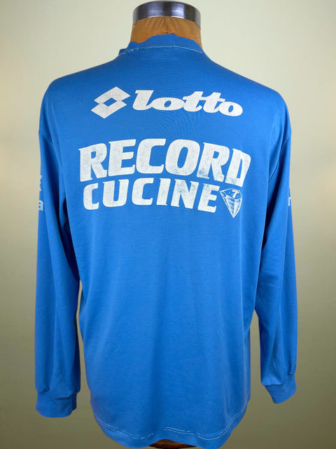Blue long-sleeve Napoli Training shirt with 'Lotto Record Cucine' text on a mannequin against a beige background