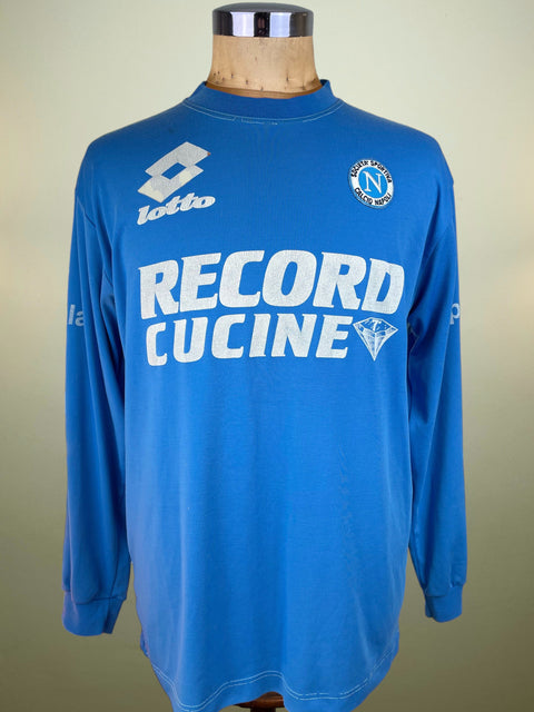 Blue long-sleeve Napoli Training shirt with visible branding on a mannequin against a neutral background