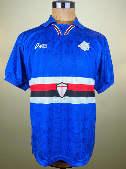 Blue Sampdoria 1996-97 Home jersey made by Asics with a logo on a mannequin against a beige background
