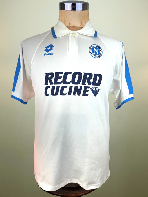 White Lotto 1995-96 Napoli Away jersey with blue accents on a mannequin against a beige background