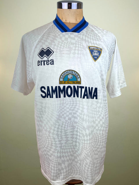 White Empoli Training Jersey jersey with blue accents on a mannequin against a beige background