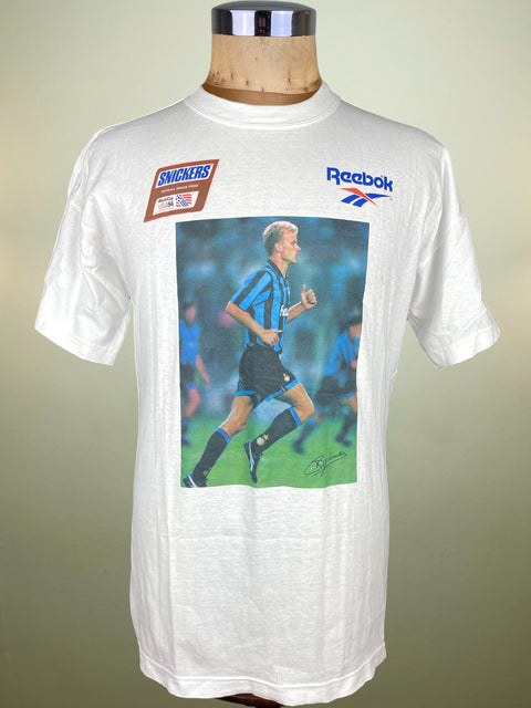 White t-shirt with Dennis Bergkamp graphic and Reebok logo on a mannequin against a beige background