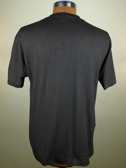 Black t-shirt on a mannequin against a plain background