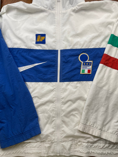 White jacket with blue and red accents featuring logos on a flat surface