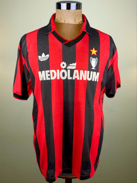 A red and black striped AC Milan soccer jersey with 'Mediolanum' written on the front made from special Nido d'Ape Fabric