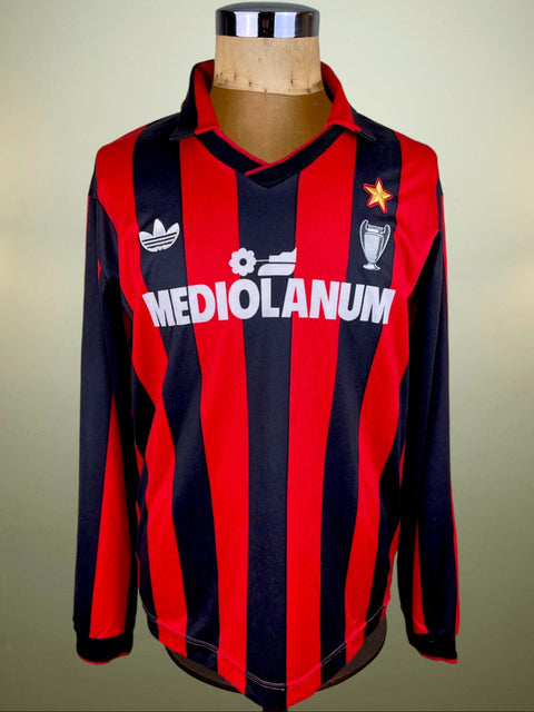 A red and black striped AC Milan soccer jersey from the 1990 match against Sampdoria, displayed on a mannequin.