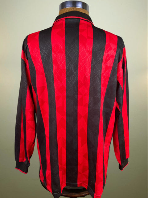 Red and black striped jacket on a mannequin against a beige background