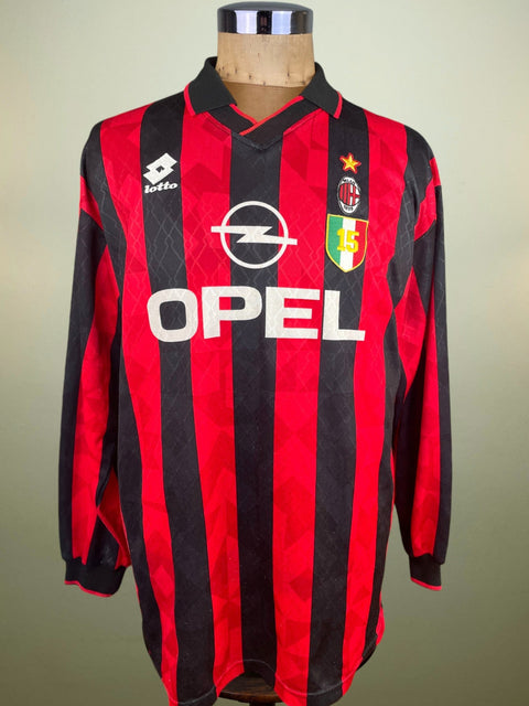 Red and black striped sports jersey with Opel logo on a mannequin against a neutral background