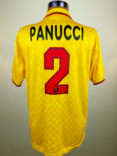 A yellow soccer jersey with the name 'PANUCCI' and the number '2' on the back, displayed on a mannequin.
