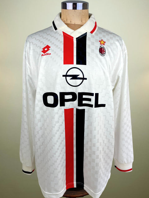 White sports jersey with red and black stripes and Opel logo on a mannequin against a neutral background
